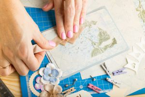 scrapbook background. Hands, Card and tools with decoration